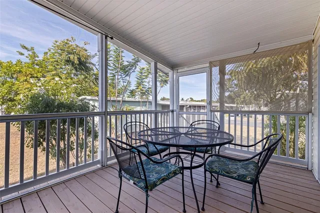 a view of a chairs and table in the balcony