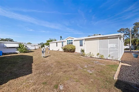 a view of a house with backyard and a garage