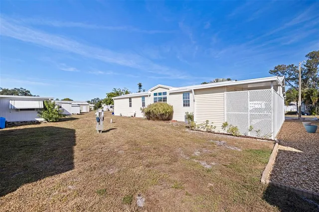 a view of a house with backyard and a garage