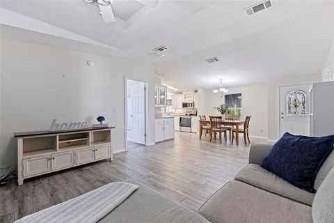 a living room with furniture and kitchen view