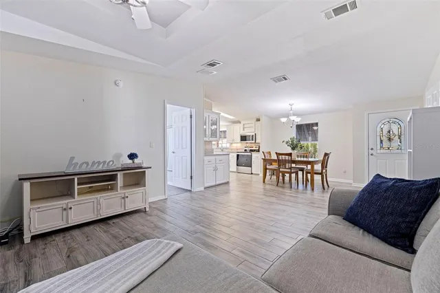 a living room with furniture and kitchen view