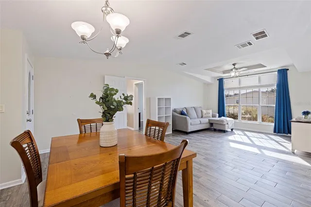 a view of a dining room with furniture and a large window