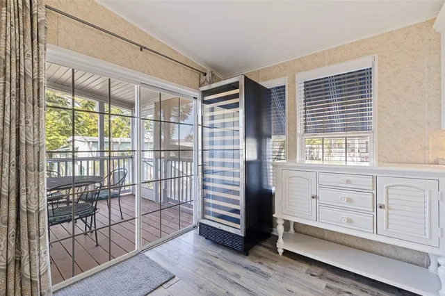a view of a bedroom with wooden floor and windows