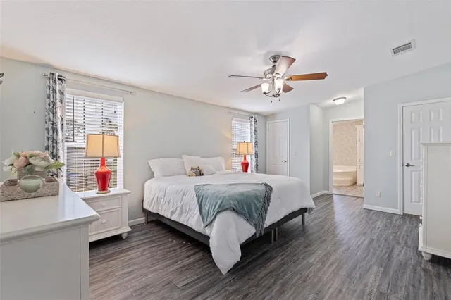 a spacious bedroom with a bed and a chandelier