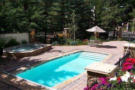 9 Vail Road, Unit 1J Vail, CO 81657 - Photo 11 of 14 a wooden bench sitting in the middle of a backyard
