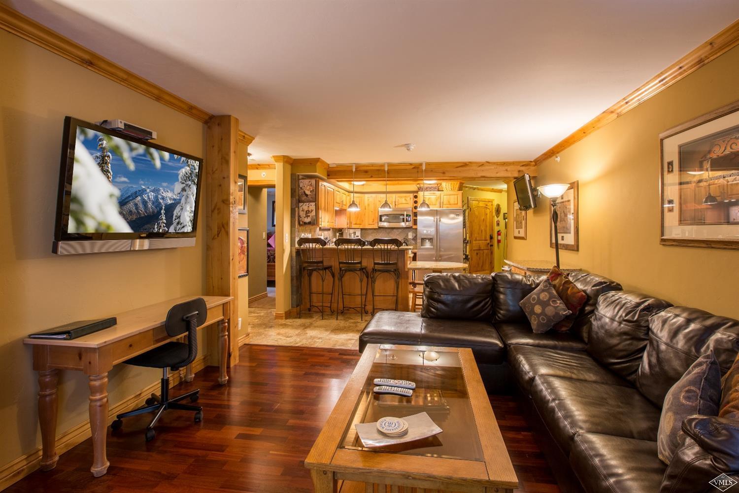 9 Vail Road, Unit 1J Vail, CO 81657 - Photo 2 of 14 a living room with furniture and a view of kitchen