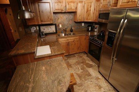 9 Vail Road, Unit 1J Vail, CO 81657 - Photo 5 of 14 a kitchen with a sink appliances and cabinets