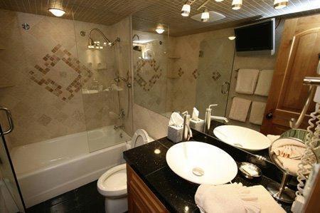 9 Vail Road, Unit 1J Vail, CO 81657 - Photo 8 of 14 a bathroom with a granite countertop sink toilet a mirror and shower