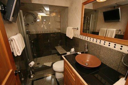 9 Vail Road, Unit 1J Vail, CO 81657 - Photo 9 of 14 a bathroom with a sink mirror vanity and toilet