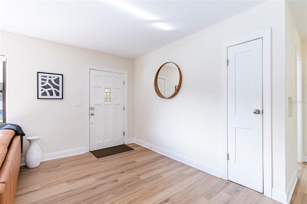 1344 Springdale Street Clearwater, FL 33755 - Photo 5 of 34 an empty room with wooden floor and mirror