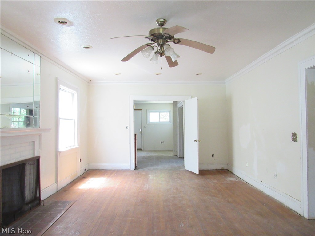 1726 Lee Road Cleveland Heights, OH 44118 - Photo 3 of 36 Spacious room featuring wood-finish flooring, a fireplace with a white mantel, recessed lighting, and a ceiling fan