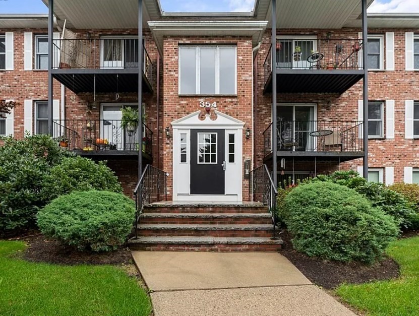 a front view of a house with a garden