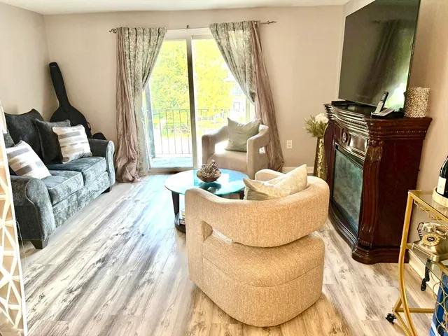 a living room with furniture fireplace and a flat screen tv
