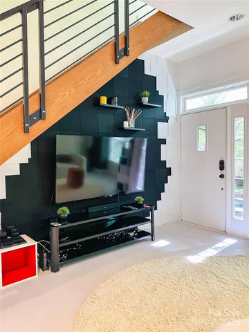 a kitchen with a dining table chairs and white cabinets