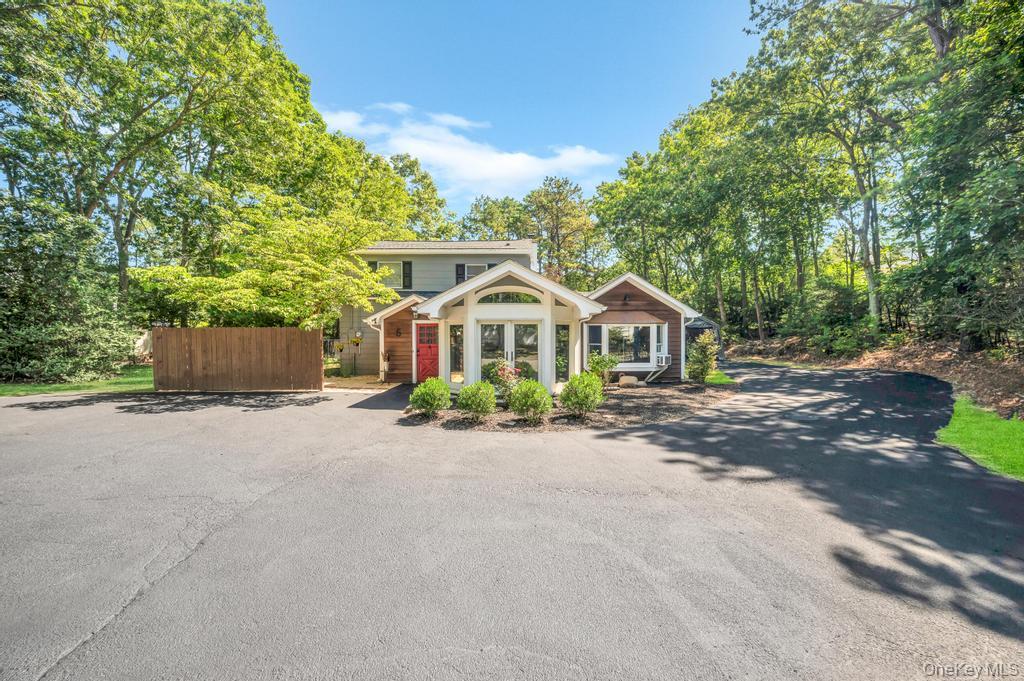 View of front of property with asphalt driveway