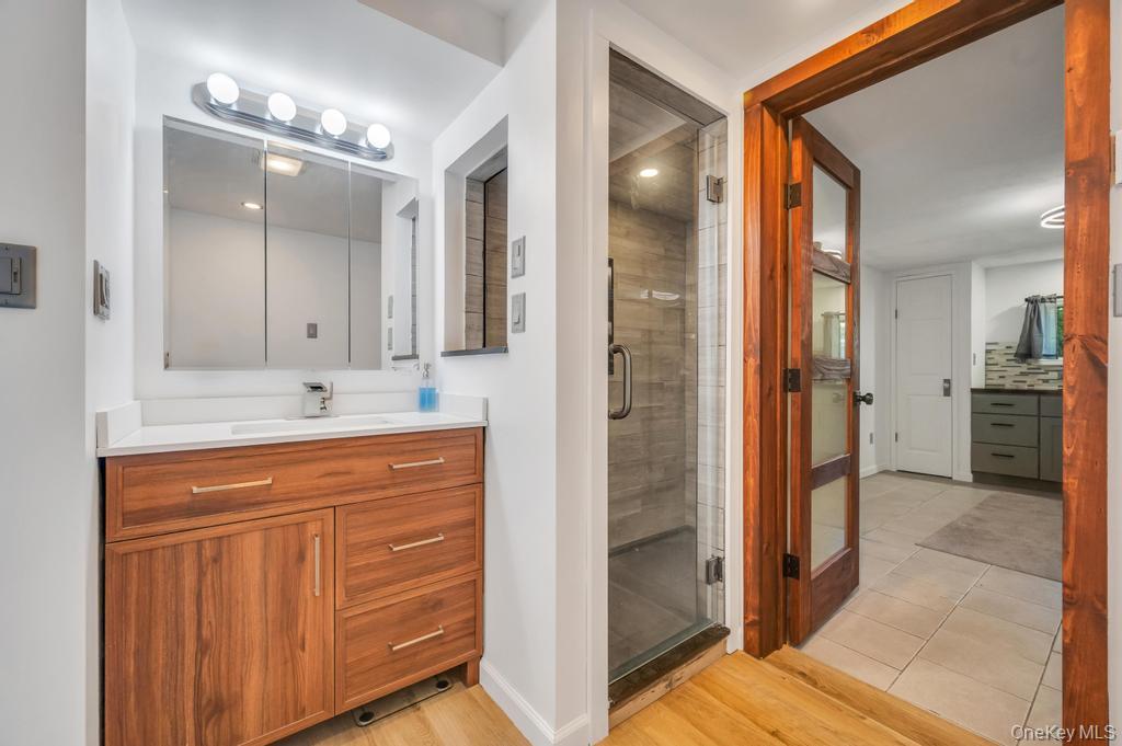 5 Panther Path Miller Place, NY 11764 - Photo 17 of 37 Full bath with vanity, a shower stall, and light wood-type flooring