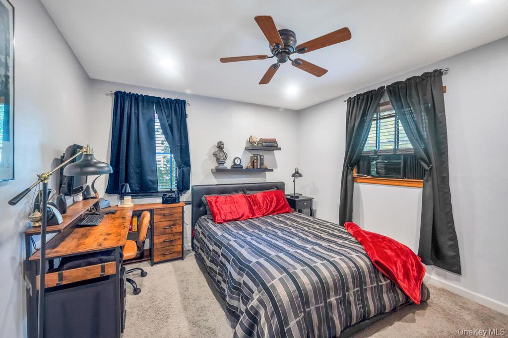5 Panther Path Miller Place, NY 11764 - Photo 33 of 37 Bedroom featuring light colored carpet, a ceiling fan, and an office area