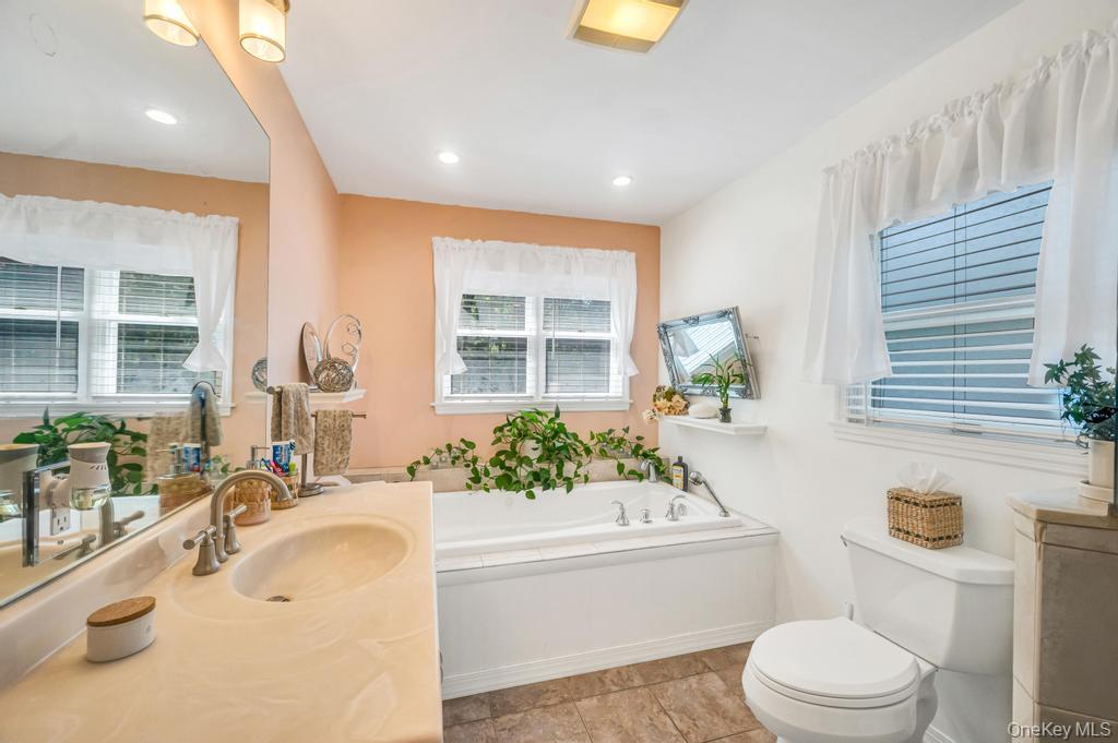 5 Panther Path Miller Place, NY 11764 - Photo 35 of 37 Full bathroom featuring a garden tub, vanity, recessed lighting, and light tile patterned floors