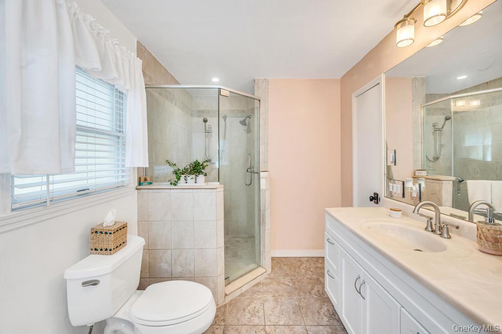 5 Panther Path Miller Place, NY 11764 - Photo 36 of 37 Bathroom with vanity, light tile patterned floors, and a stall shower