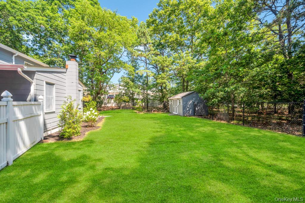 5 Panther Path Miller Place, NY 11764 - Photo 7 of 37 Fenced backyard with a storage shed