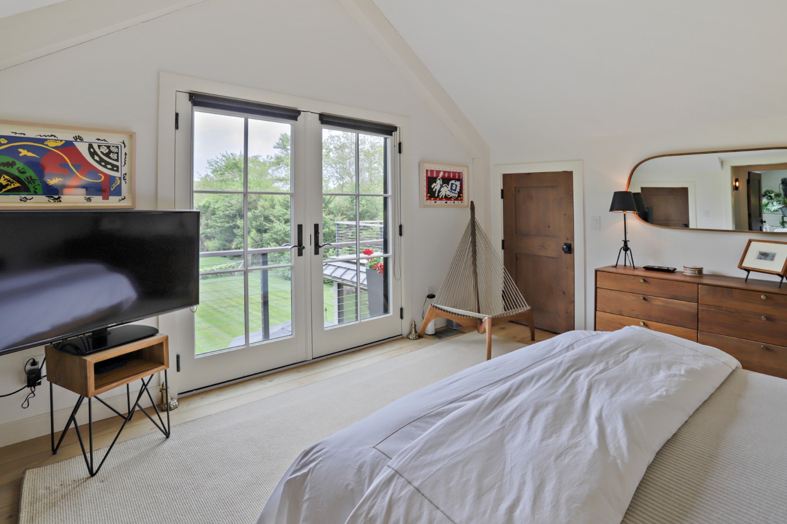 9 Ridge Hill Road Chilmark, MA 02535 - Photo 25 of 48 a bedroom with a bed and large windows