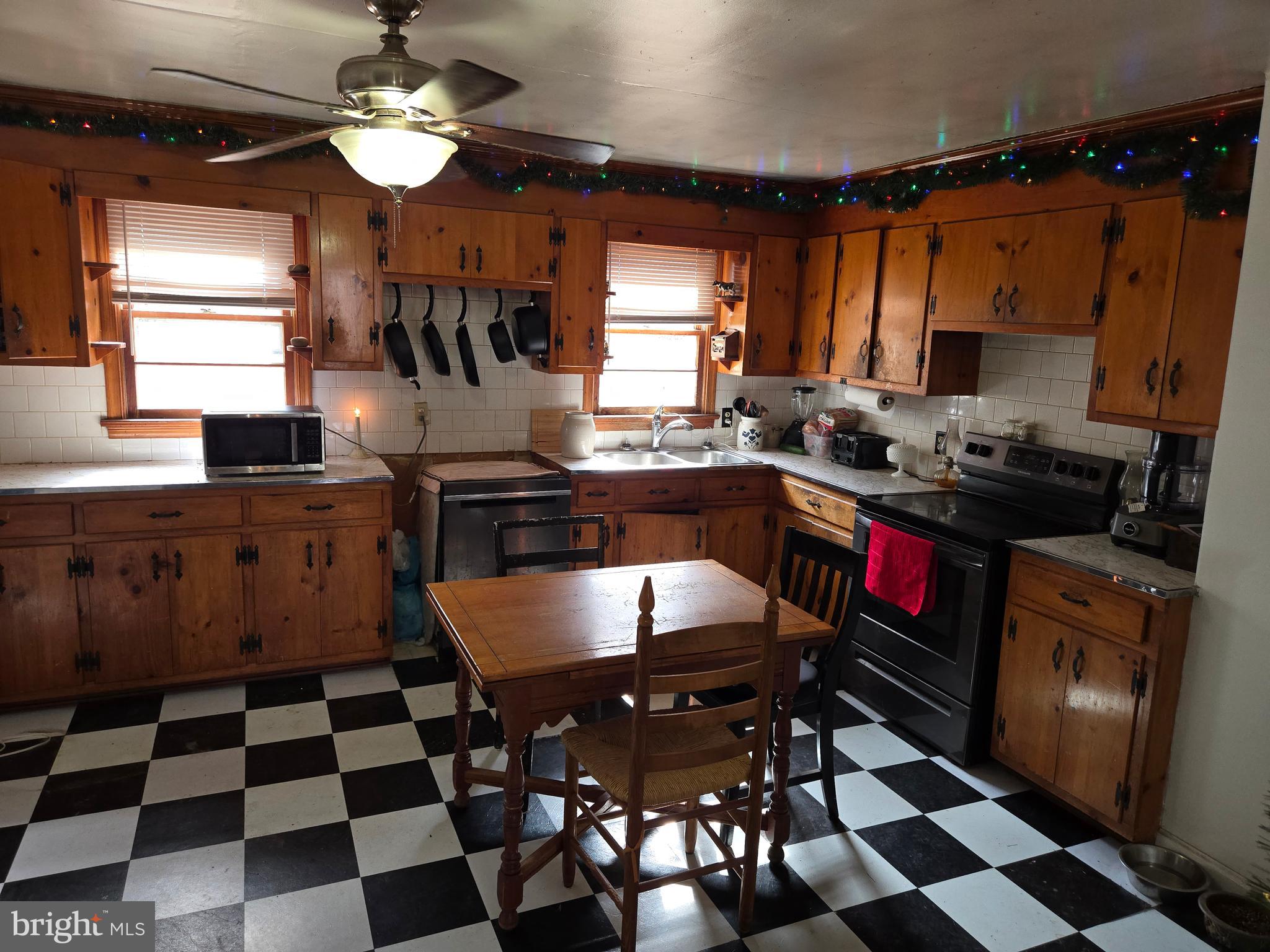 2996 Etlan Road Etlan, VA 22719 - Photo 7 of 24 a kitchen with a sink a stove a dining table and chairs