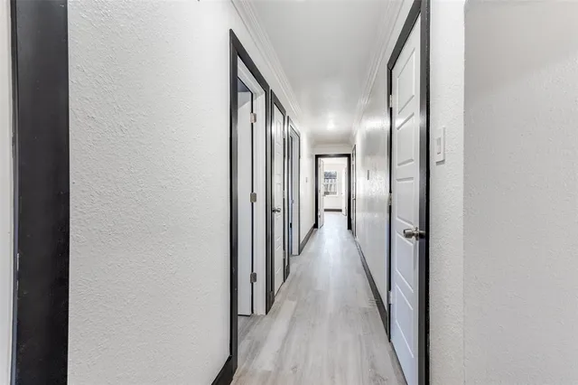 a view of a hallway with wooden floor