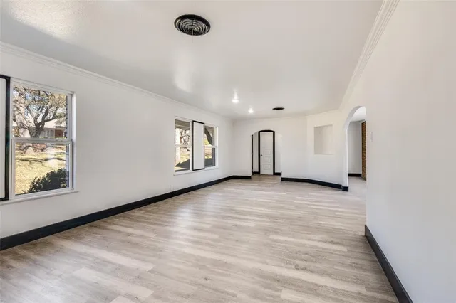 a view of a livingroom with wooden floor and window