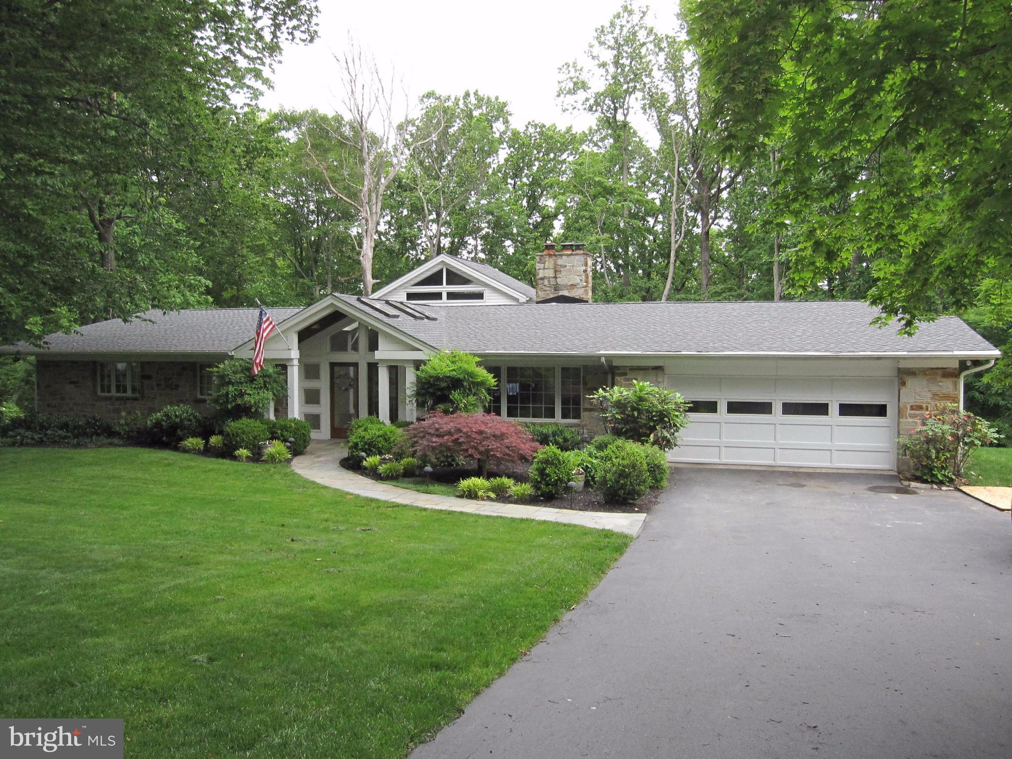 906 Huntsman Road Baltimore, MD 21286 - Photo 1 of 30 a front view of a house with a garden and plants