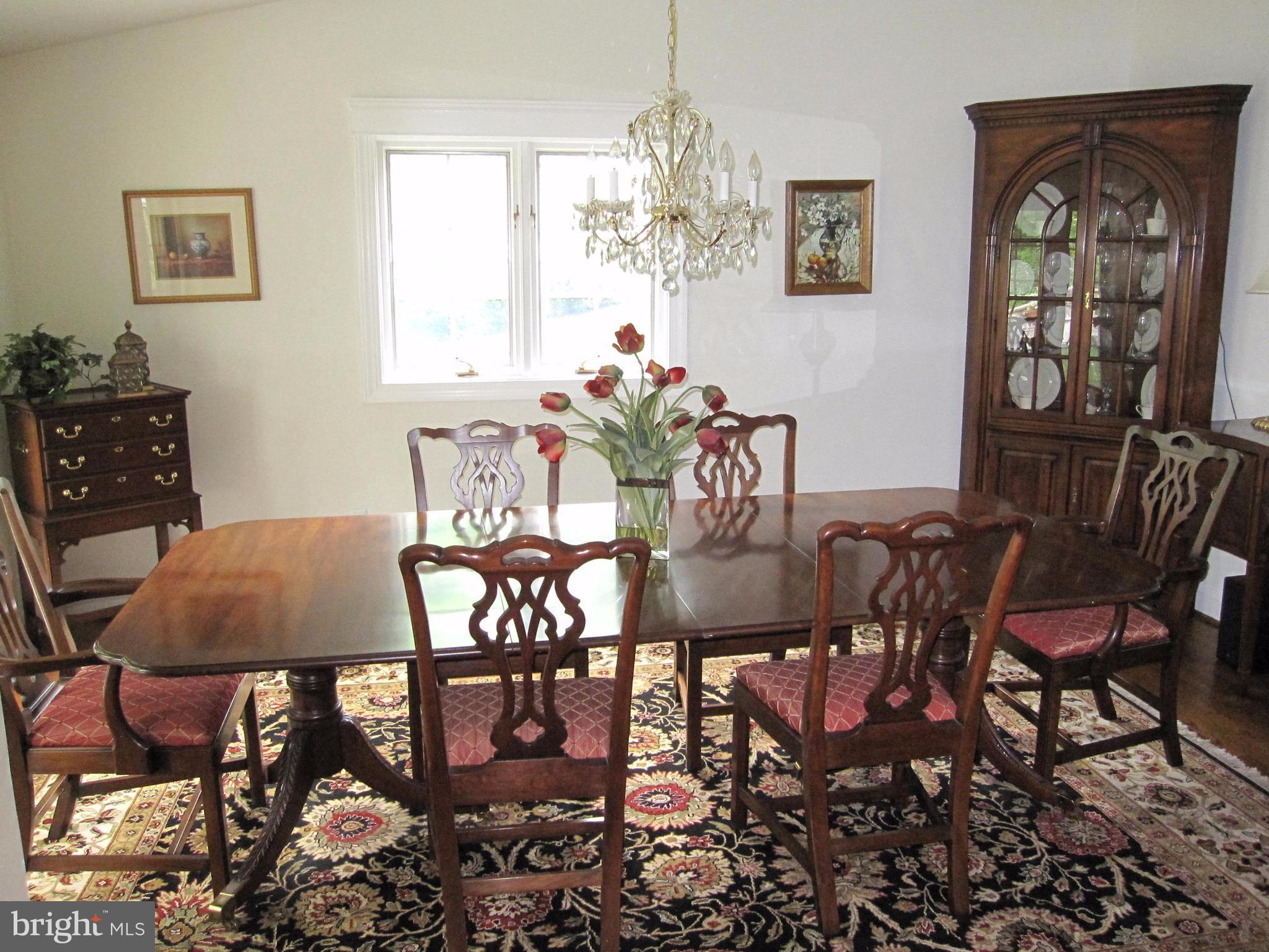 906 Huntsman Road Baltimore, MD 21286 - Photo 11 of 30 a dining room with furniture a rug and a chandelier