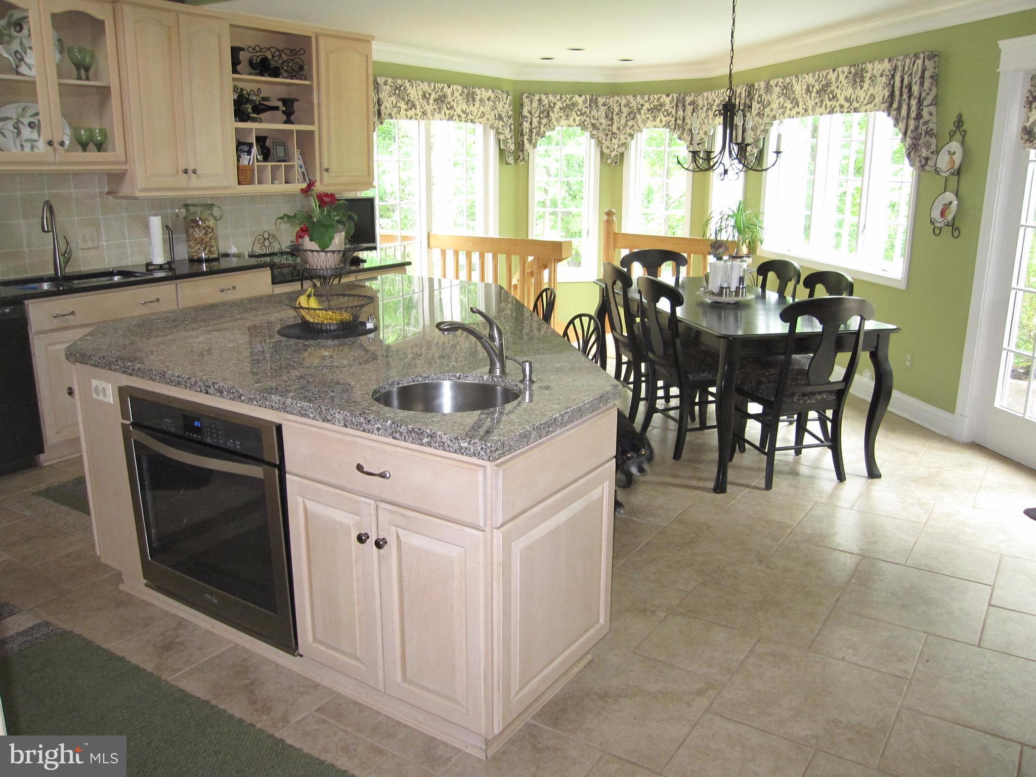 906 Huntsman Road Baltimore, MD 21286 - Photo 13 of 30 a kitchen with stainless steel appliances granite countertop a stove a sink and a microwave