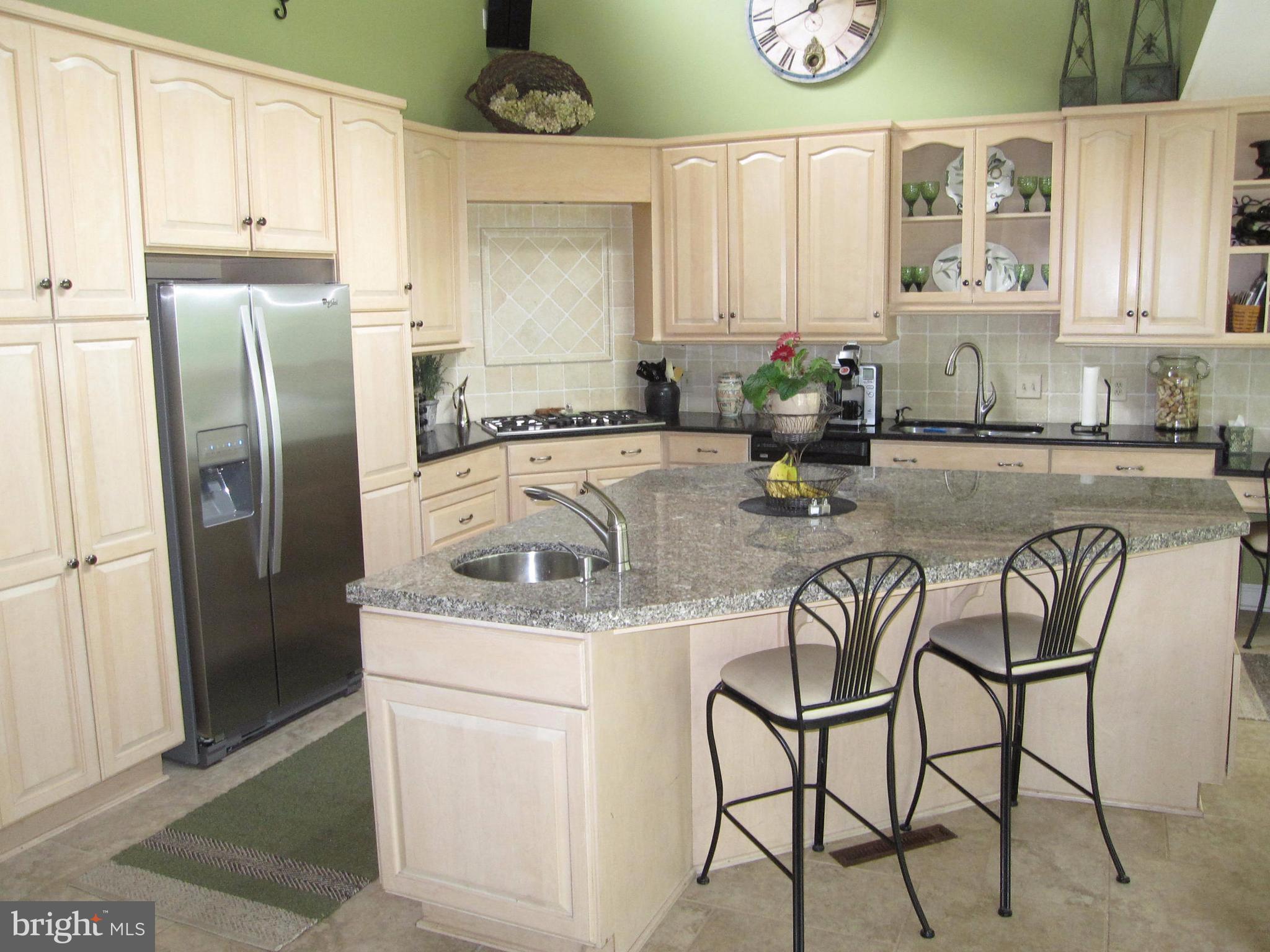 906 Huntsman Road Baltimore, MD 21286 - Photo 14 of 30 a kitchen with stainless steel appliances granite countertop a sink and a refrigerator