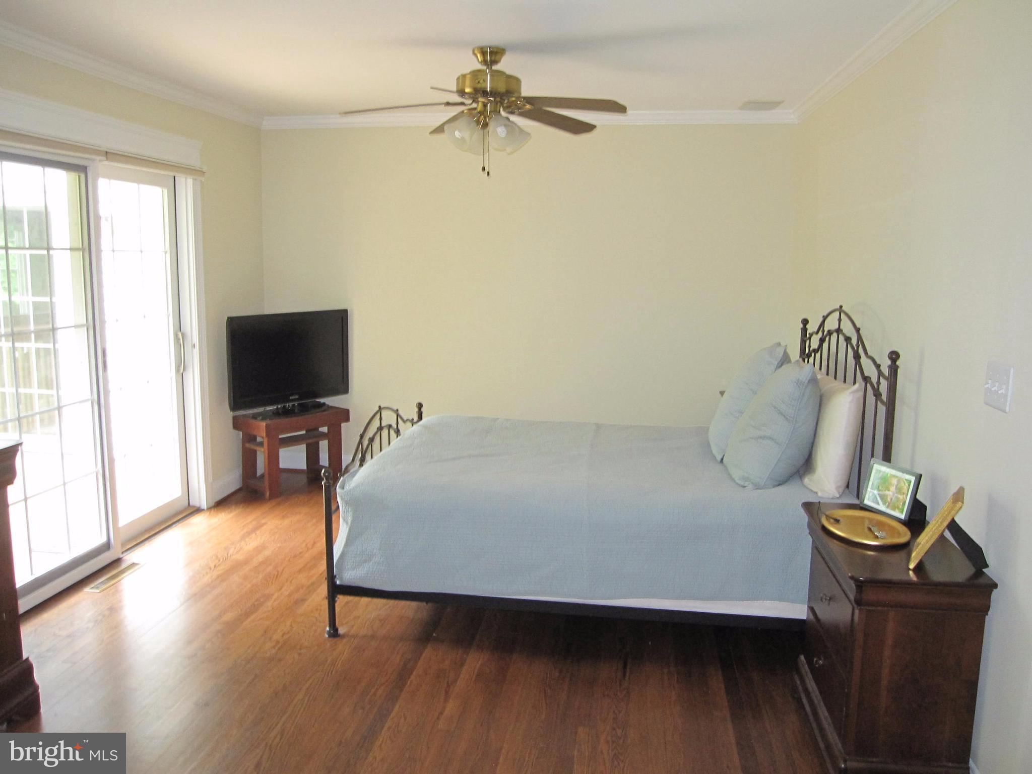 906 Huntsman Road Baltimore, MD 21286 - Photo 16 of 30 a bedroom with a bed and a flat screen tv