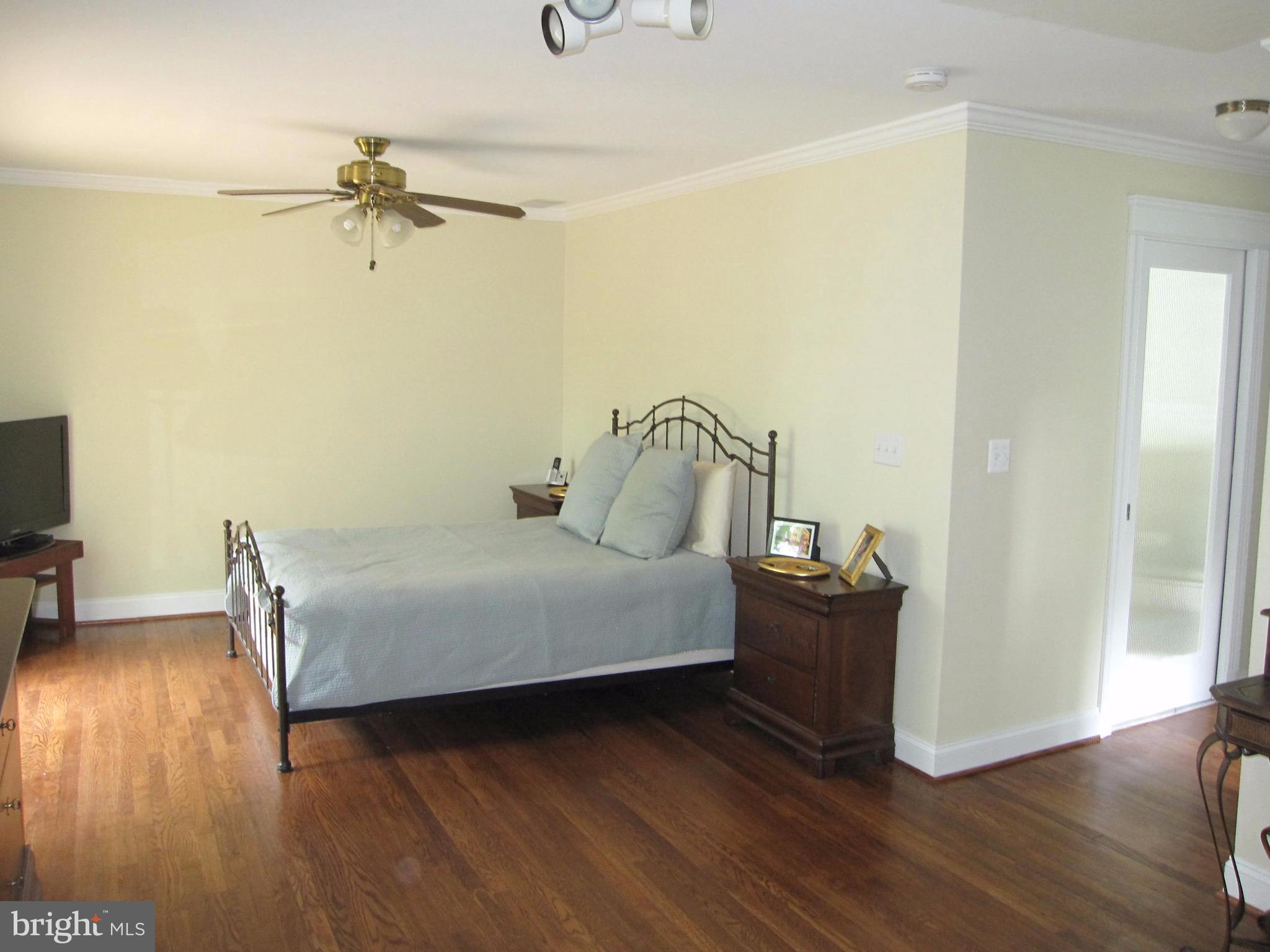 906 Huntsman Road Baltimore, MD 21286 - Photo 17 of 30 a bedroom with a bed and wooden floor