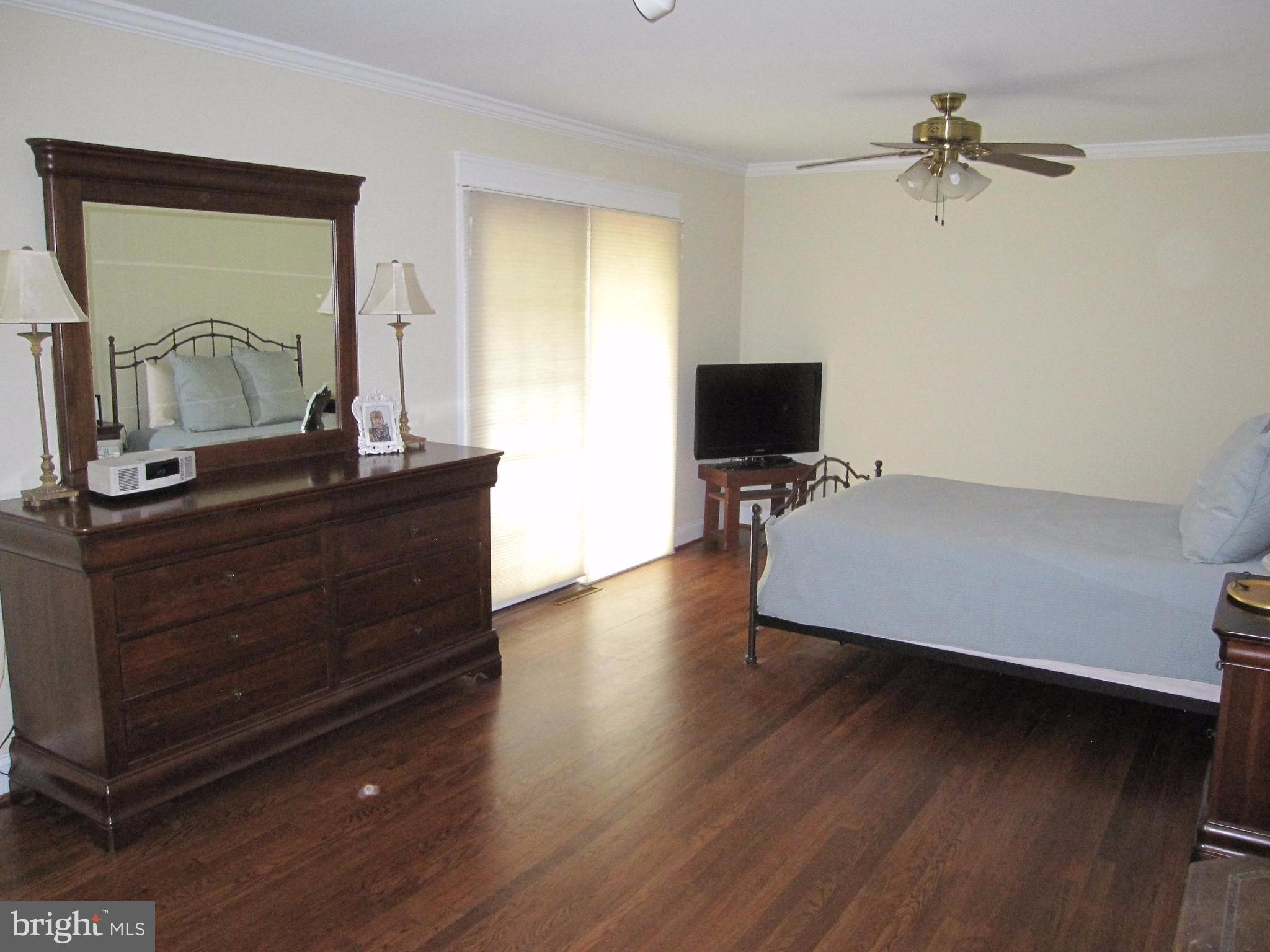 906 Huntsman Road Baltimore, MD 21286 - Photo 19 of 30 a bedroom with a bed and a mirror on the dresser