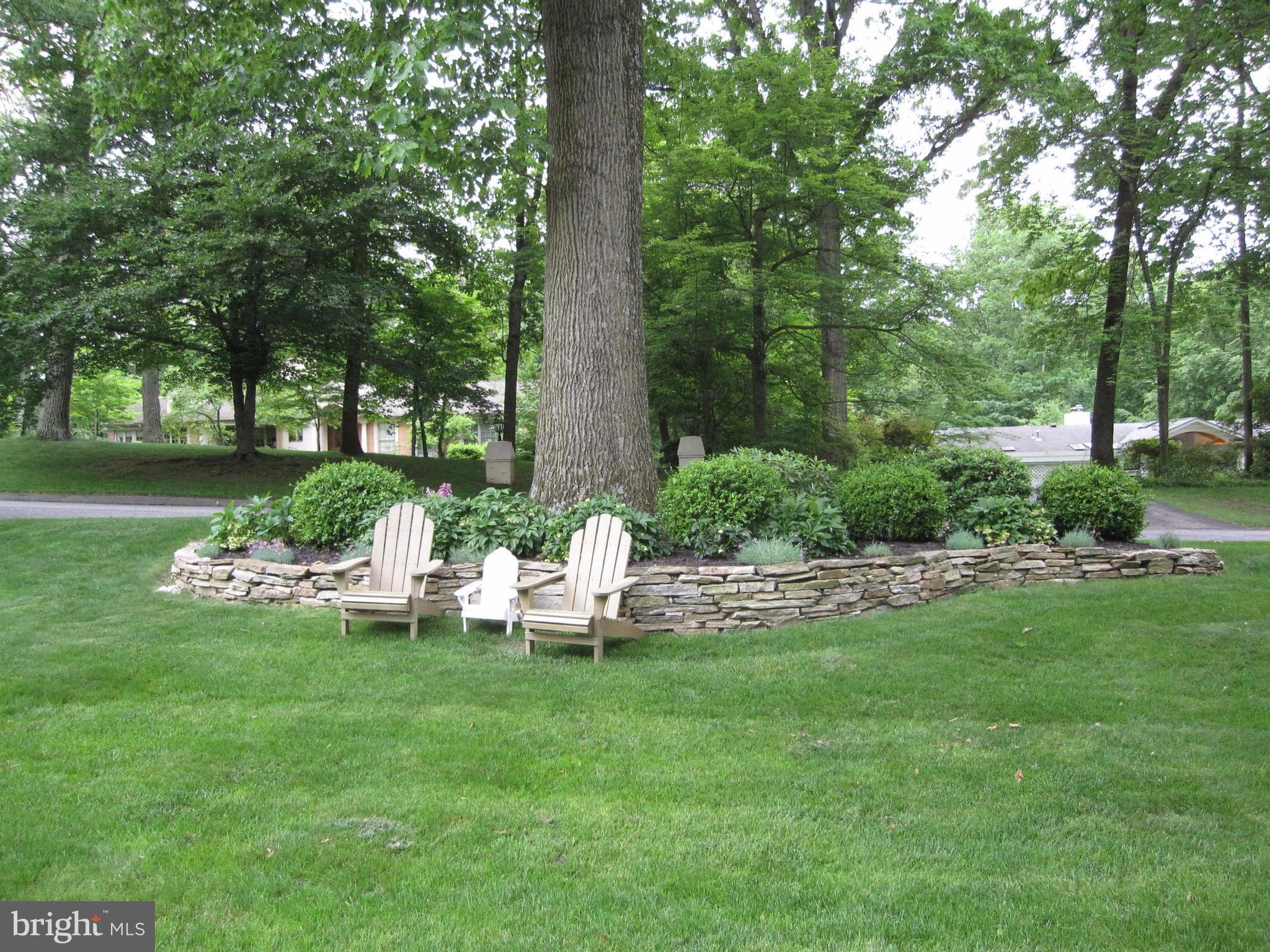 906 Huntsman Road Baltimore, MD 21286 - Photo 3 of 30 a view of a lake with lawn chairs and large trees