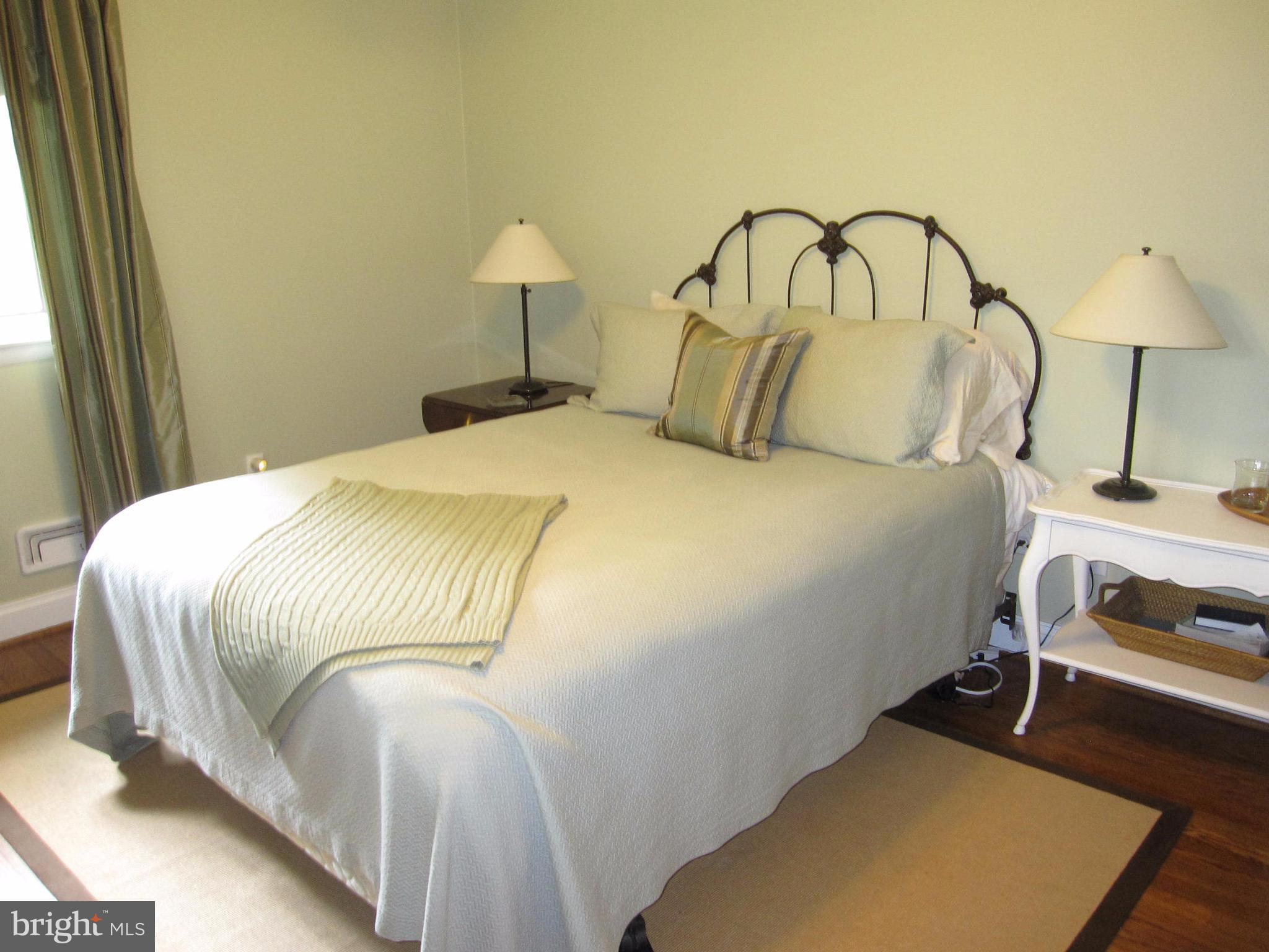 906 Huntsman Road Baltimore, MD 21286 - Photo 21 of 30 a bedroom with a bed and a lamp on table
