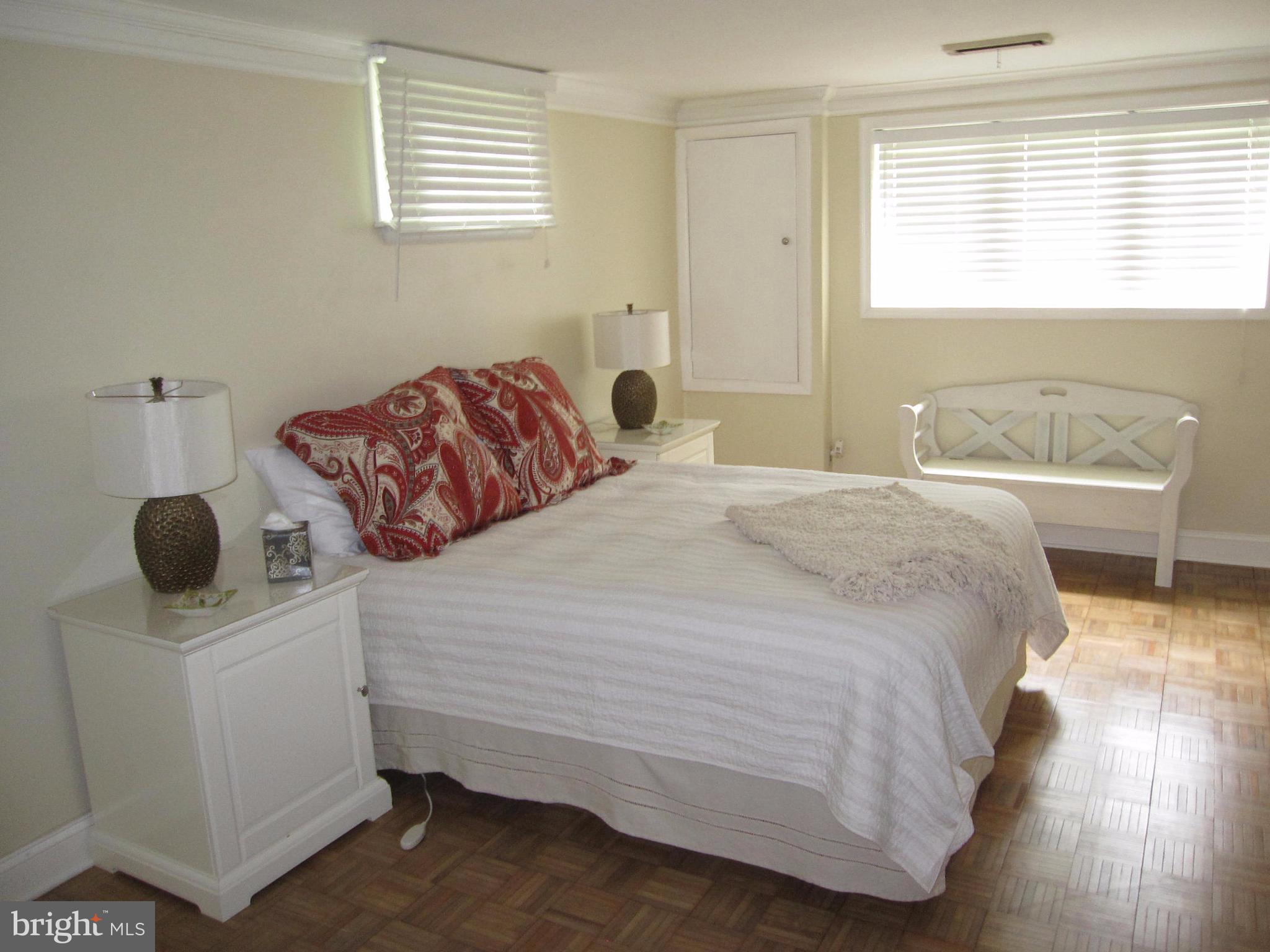 906 Huntsman Road Baltimore, MD 21286 - Photo 23 of 30 a bedroom with a bed and a table in it