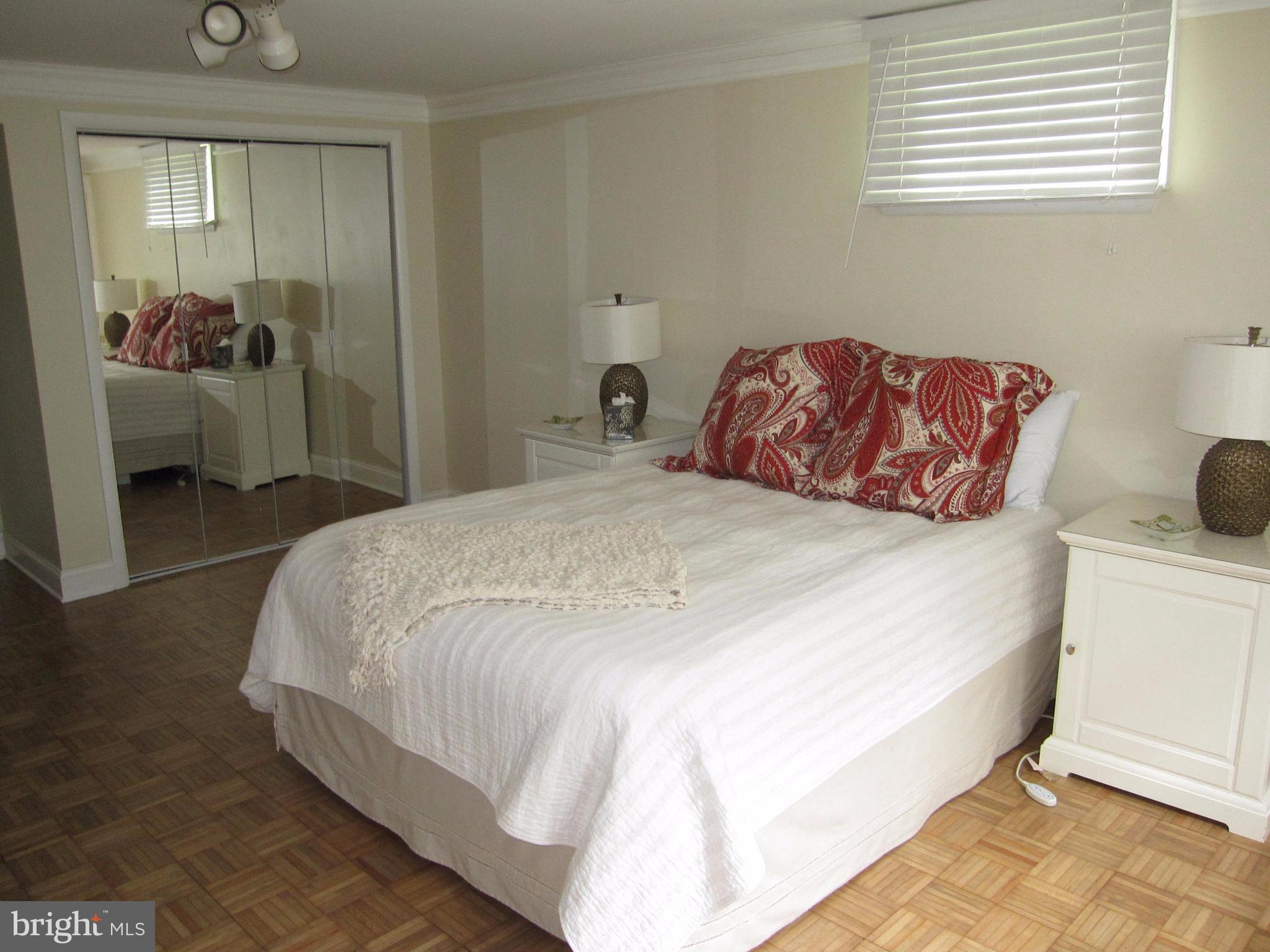 906 Huntsman Road Baltimore, MD 21286 - Photo 24 of 30 a bedroom with a bed and lamp