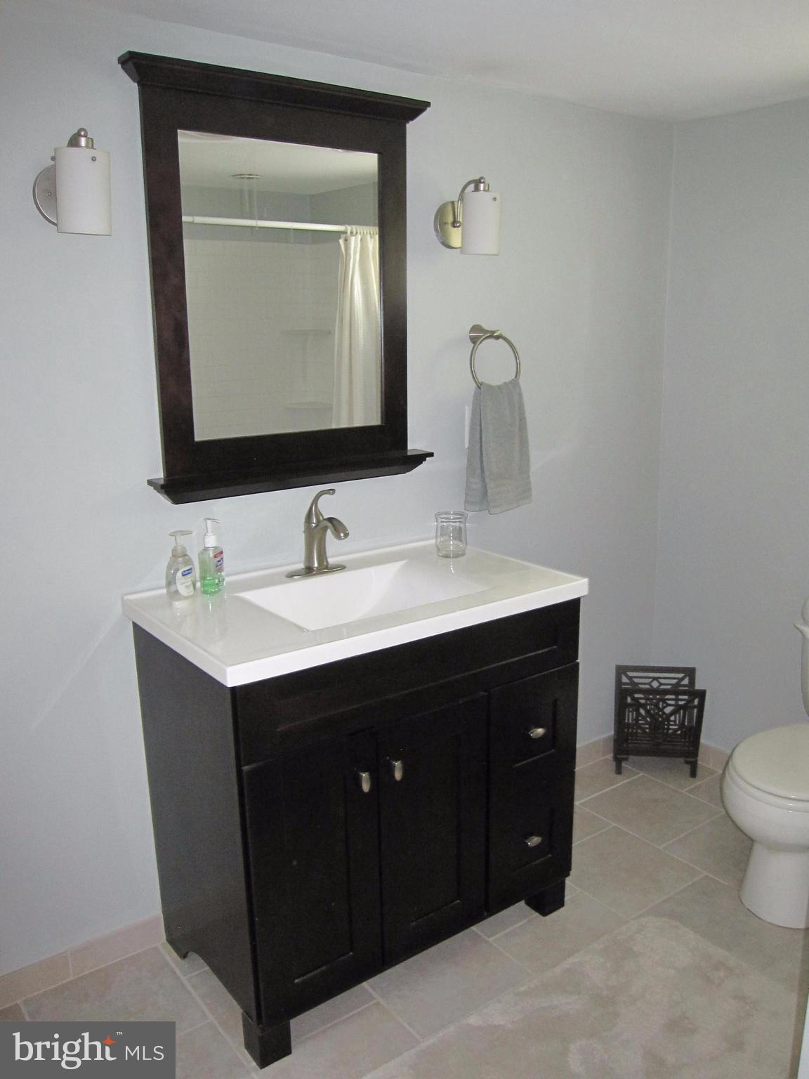 906 Huntsman Road Baltimore, MD 21286 - Photo 25 of 30 a bathroom with a sink vanity and mirror