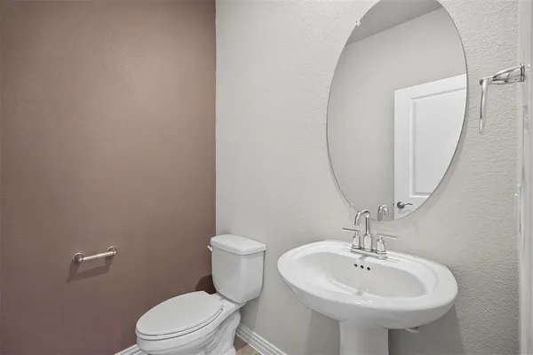 a bathroom with a sink a toilet and mirror