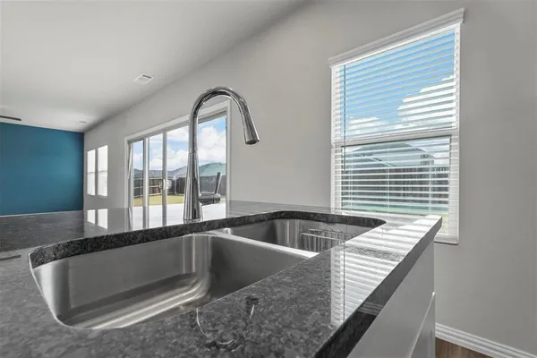 a view of a kitchen counter top space with windows