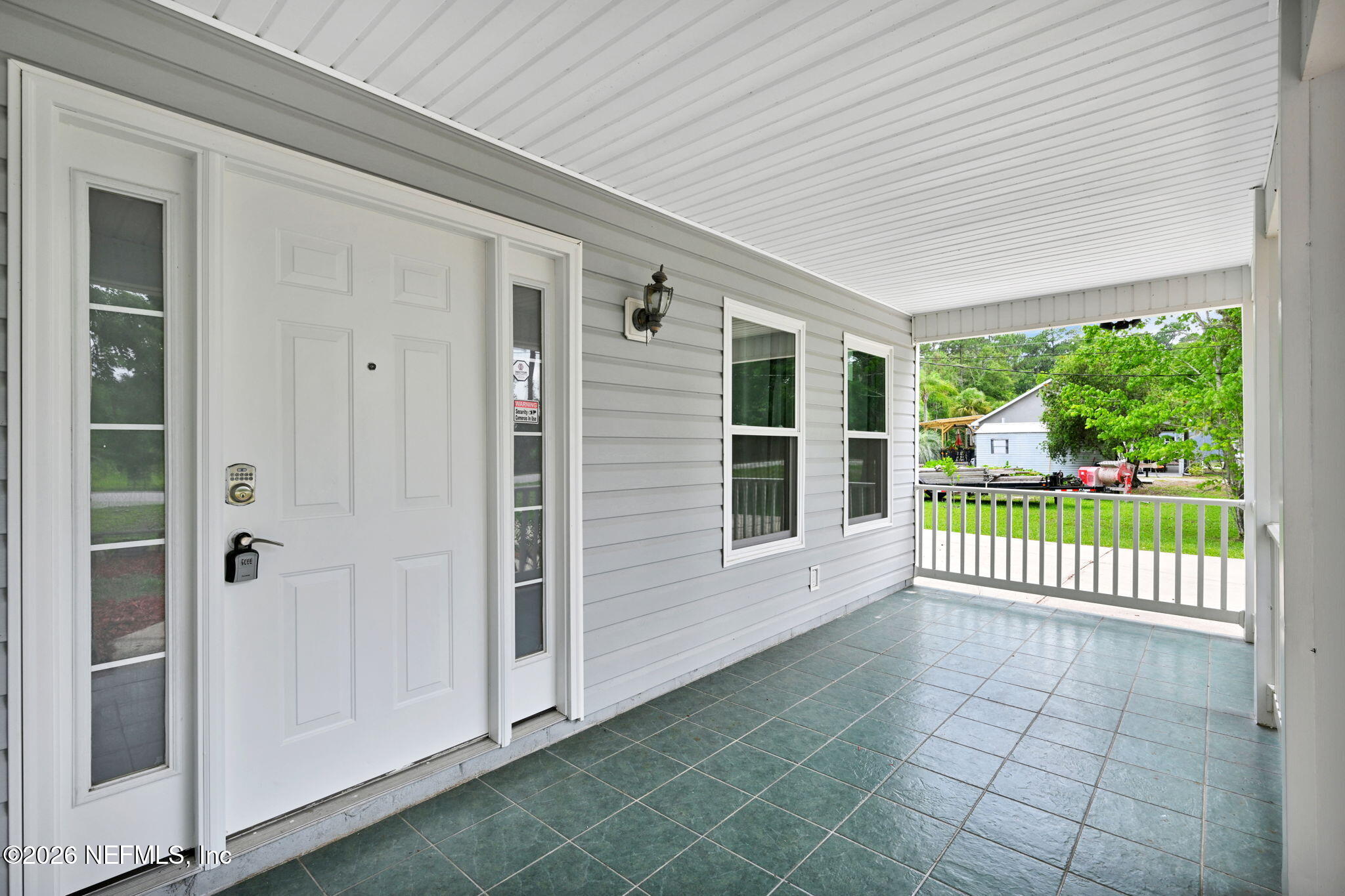 1110 Woodlawn Road, Unit D St. Augustine, FL 32084 - Photo 7 of 40 a view of a porch with wooden floor and fence