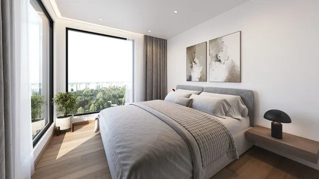 a bedroom with a bed and a large window