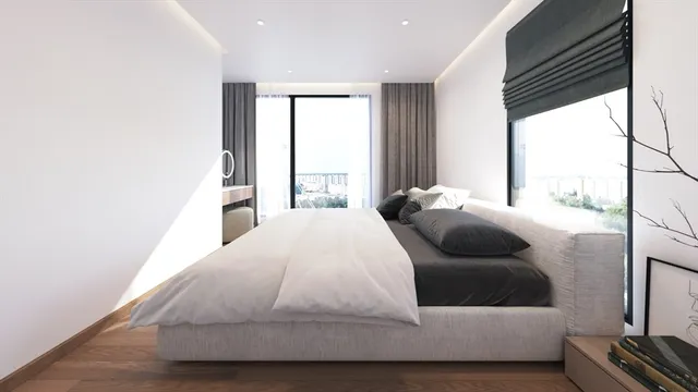 a bedroom with a bed and glass window