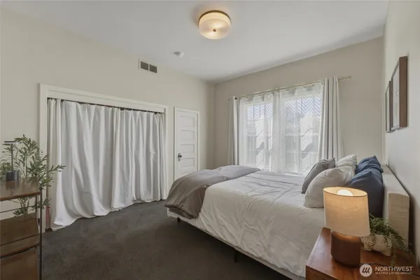 a bedroom with a bed and a window