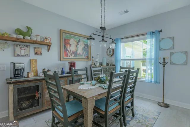 a view of a dining room with furniture window and wooden floor