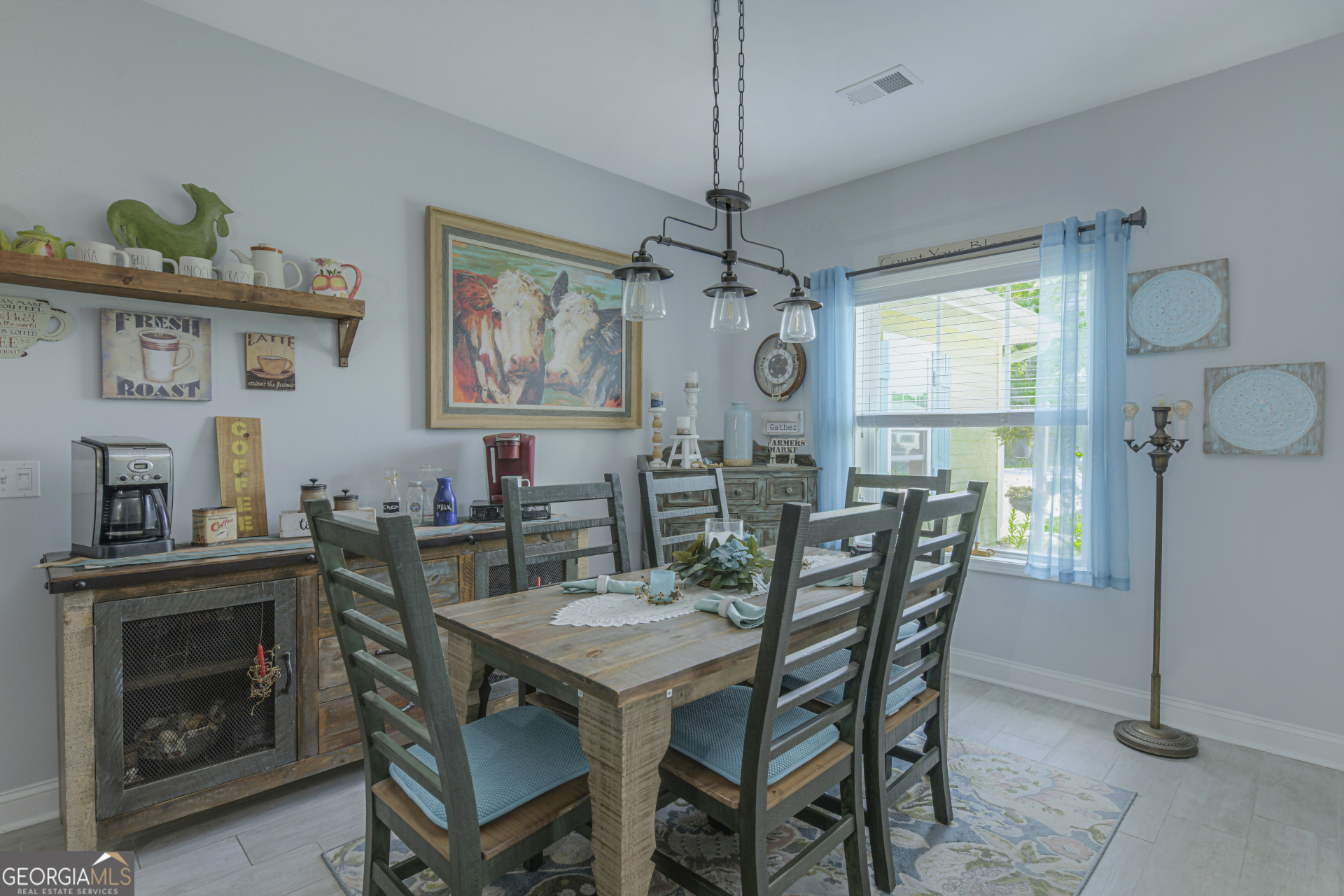 107 Elmo H Circle St. Marys, GA 31558 - Photo 11 of 31 a view of a dining room with furniture window and wooden floor