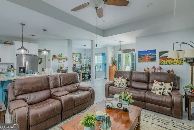 a living room with furniture and a chandelier