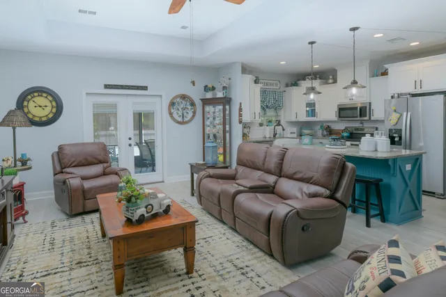 a living room with furniture kitchen view and a table